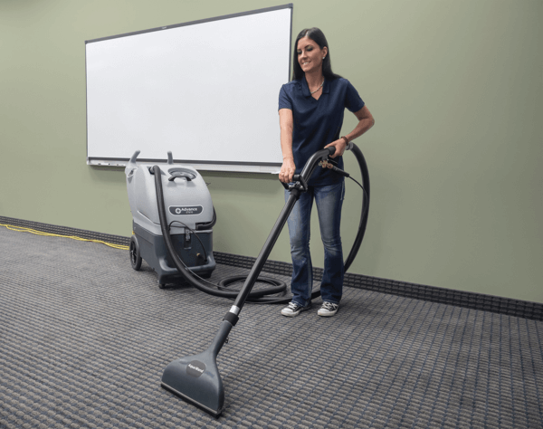 https://www.conger.com/wp-content/uploads/2022/03/advance-et610-carpet-walk-behind-floor-scrubber-with-cord-in-use.png