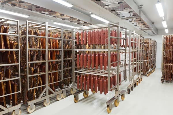Carts holding meat products inside a cold room