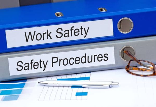Binders containing documents on work safety and procedures